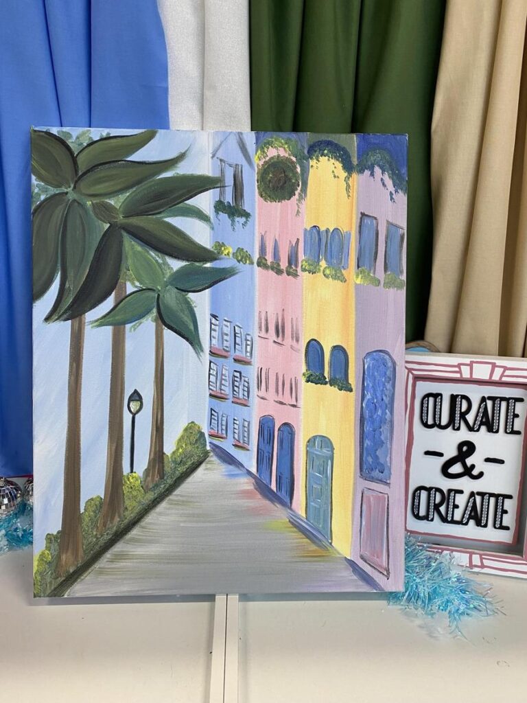 A colorful painting of a street lined with palm trees and buildings, with a sign reading "Curate & Create.