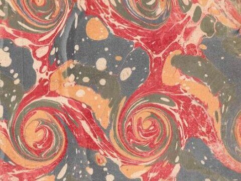 Colorful marbled paper with swirling patterns in red, blue, green, and cream.