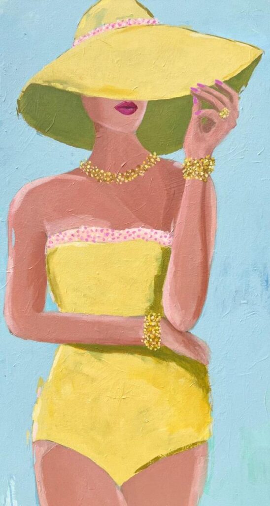 A woman in a yellow swimsuit and wide-brimmed hat poses, holding her hat and wearing jewelry.
