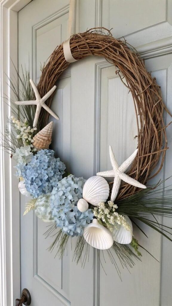 A decorative wreath with blue hydrangeas, seashells, and starfish hangs on a light blue door.