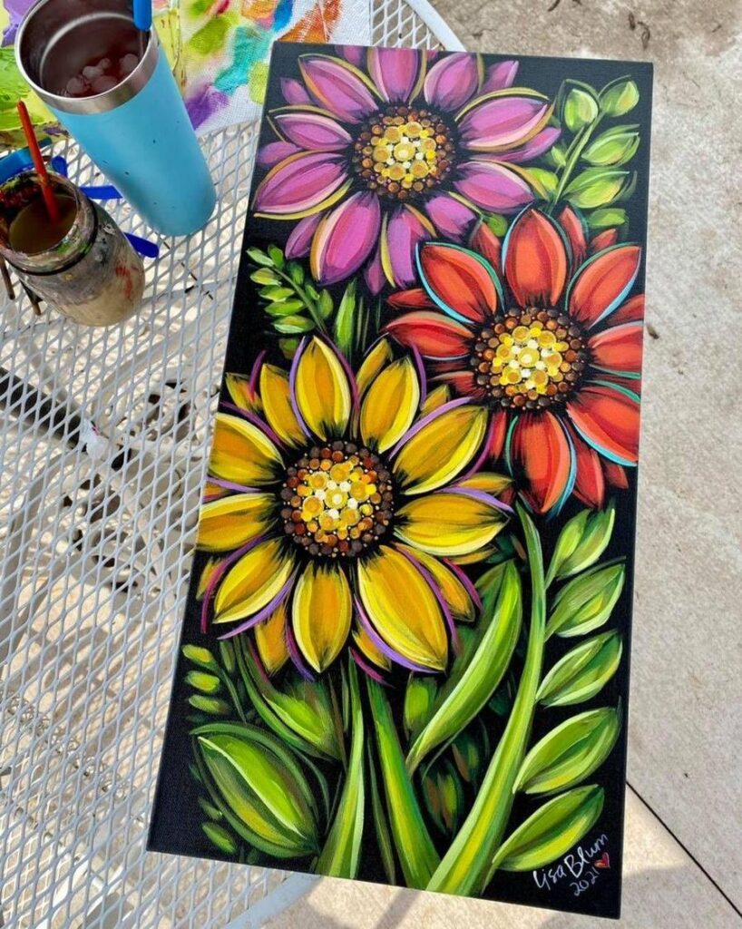 Colorful painting of three flowers—pink, red, and yellow—surrounded by green leaves on a black background.
